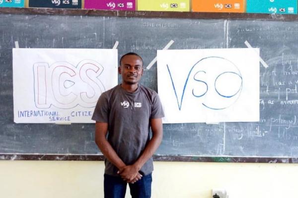 Nicholaus stood in front of VSO and OCS signs in a classroom