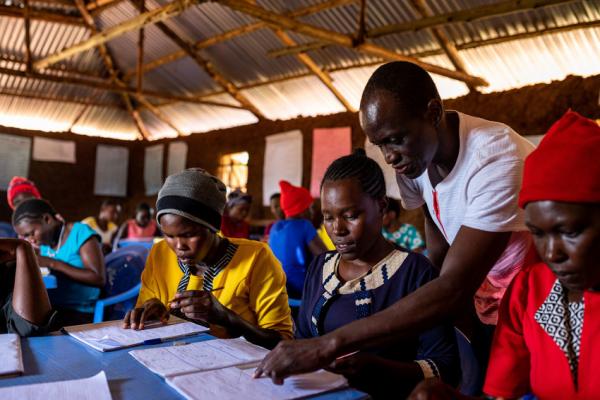 Volunteer Peter helps some pupils at a VSO-supported learning centre