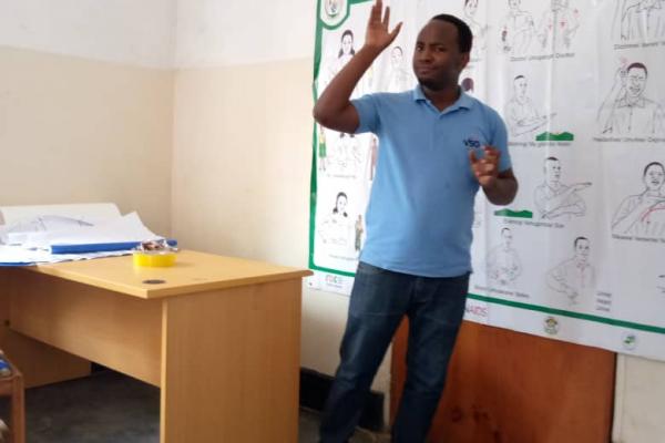 Eric Ngabonziza teaches sexual health messages to a class of students.