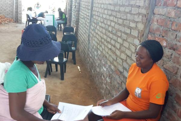 Legal practitioner Loice Mazvita meets with a woman experiencing domestic abuse.