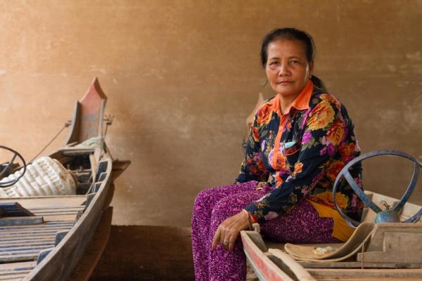 Farmer Yu Saret sits on a boat.