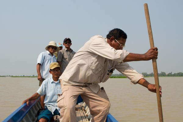 Fishermen steer a boat through the Tonle Sap lake.