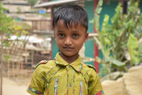 Boy stands in front of camera in Cox's Bazar Refugee settlement 