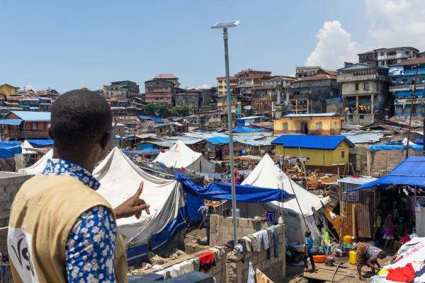 Sam looks over the slum at Susan's Bay