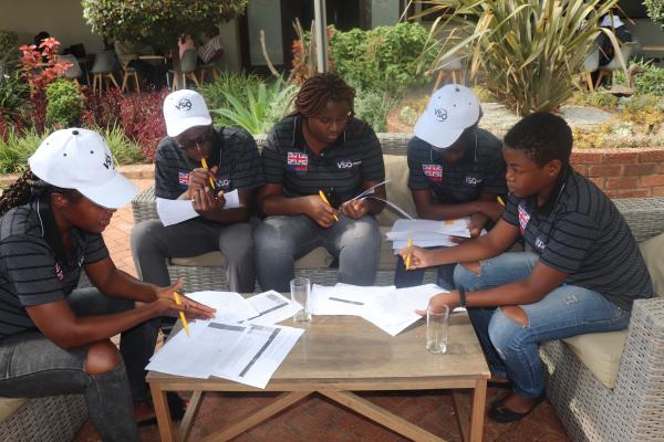 Group of youth volunteers reviewing documents with false COVID-19 information