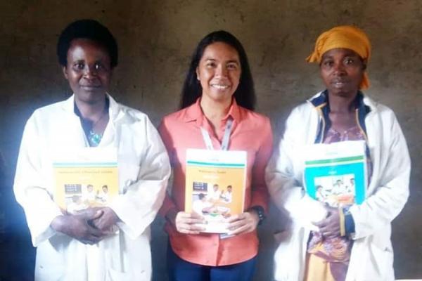 Jessica and student teachers holding education materials.