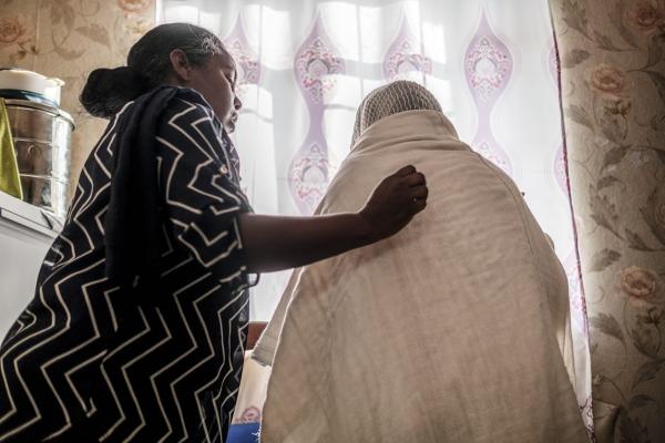 Woman is given a blanket 
