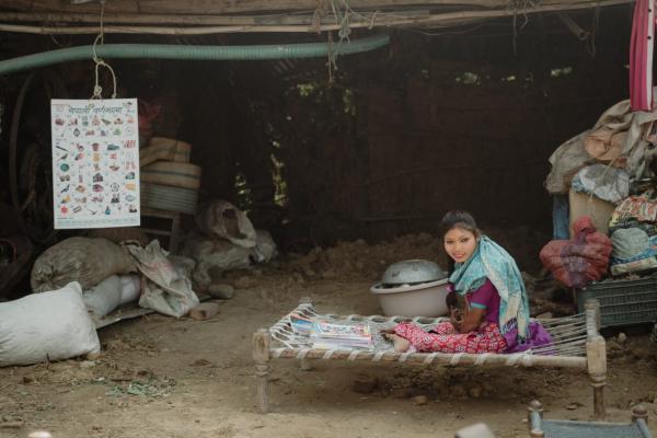 A young girl born with cerebral palsy sits in bed
