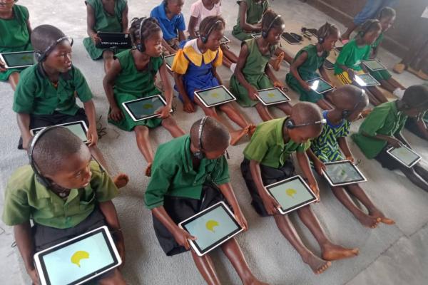 Primary school students working with laptops. Yendema. Sierra Leone.