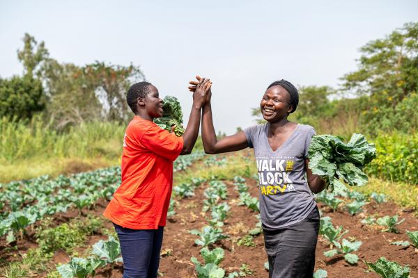 Female farmers high-fiving