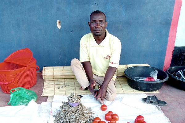 Disabled man selling fruit