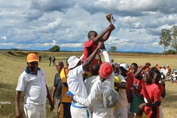 Football team lifting trophy