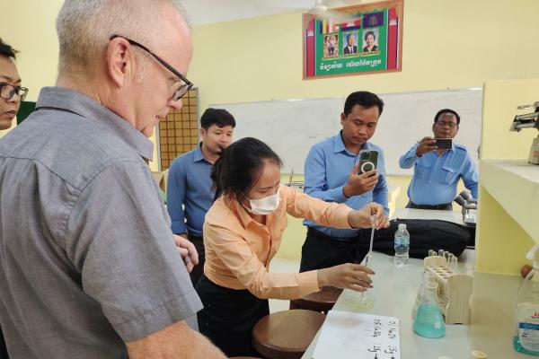 Volunteer works with Cambodian science teachers