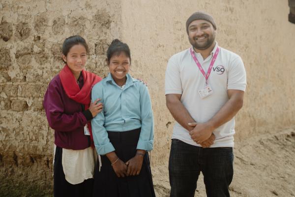 Volunteer's supporting a student with disabilities in Nepal.
