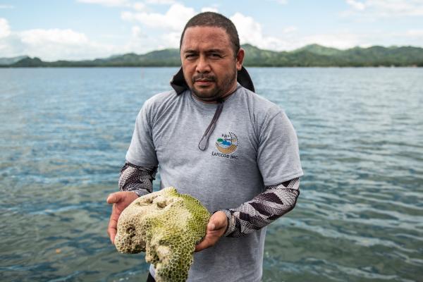 Project executive director Neil Antoque holds a coral