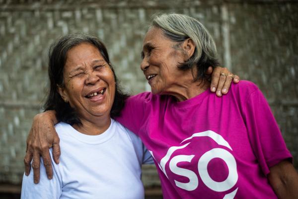 Pilipino community volunteer Jovencia laughs with her friend 