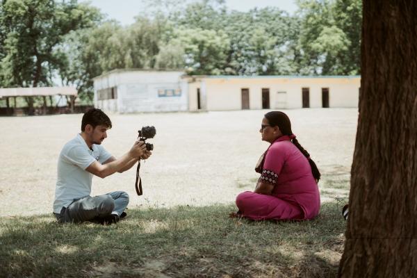 Volunteer Raj filming a primary actor with a camera.
