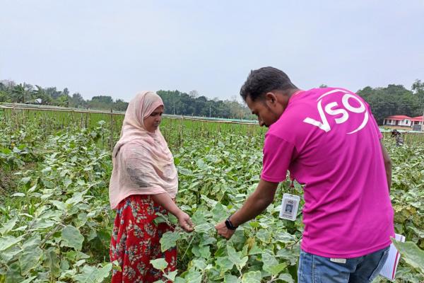 Volunteer and farmer in field