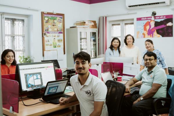 Volunteer Raj in the Kathmandu VSO office with staff members.