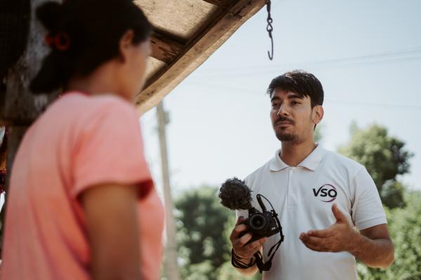 Volunteer Raj talking to a lady.