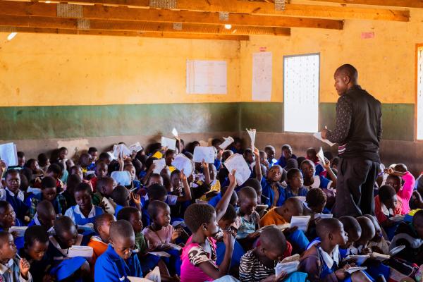 Teacher with busy class in Malawi