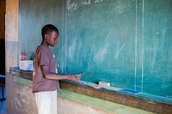 Child using a blackboard
