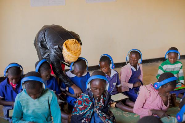 Teacher and children in Malawi, VSO learning centre