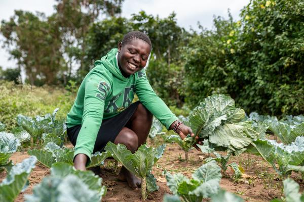 Woman tending to crops on a farm