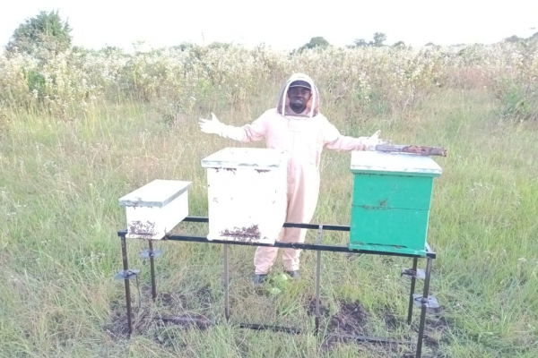 Emeka with beehives