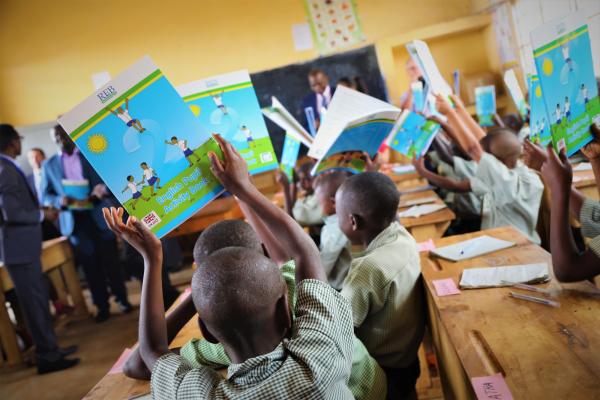 children holding text books