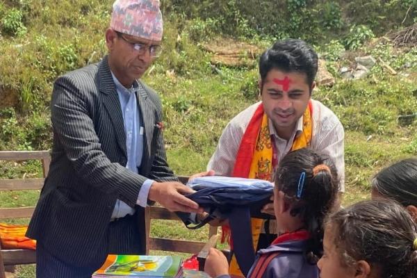 Delivering uniforms, bags and stationery to marginalized children. Janakalyan Secondary School, Baglung, Nepal.