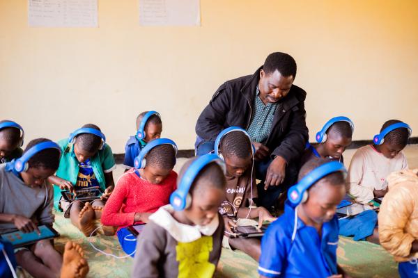 Theo sits in the learning centre with a student