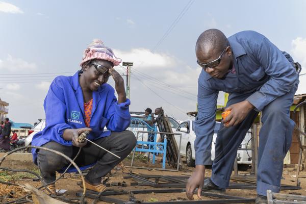 Woman learns welding from a mentor