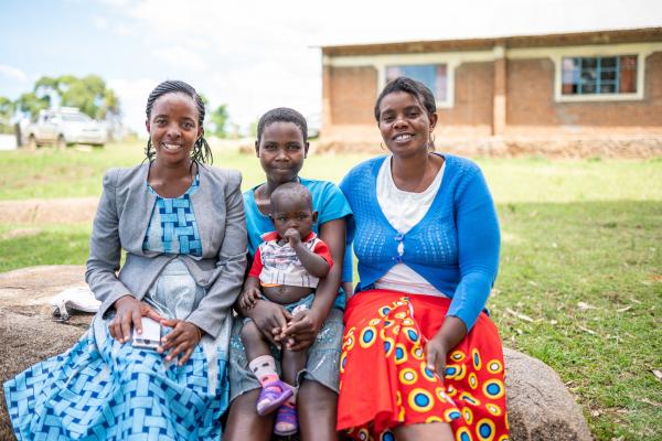 Two women and a young girl with a baby on her lap