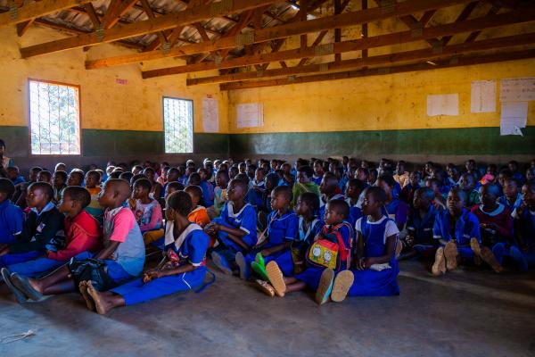 A classroom in a primary school in Malawi with over 200 students sat on the floor