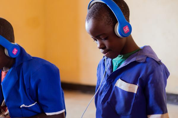 Student Lonjezo learning on an educational tablet.