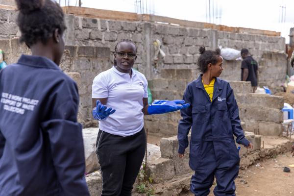 Elizabeth, waste picker, with VSO volunteer