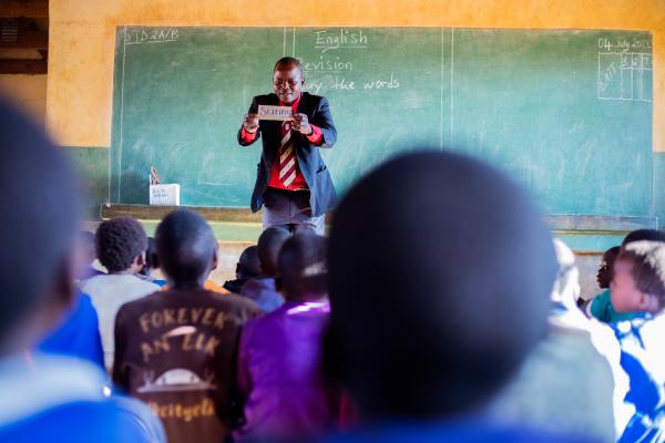 Teacher Peter, teaching a lesson in a classroom.
