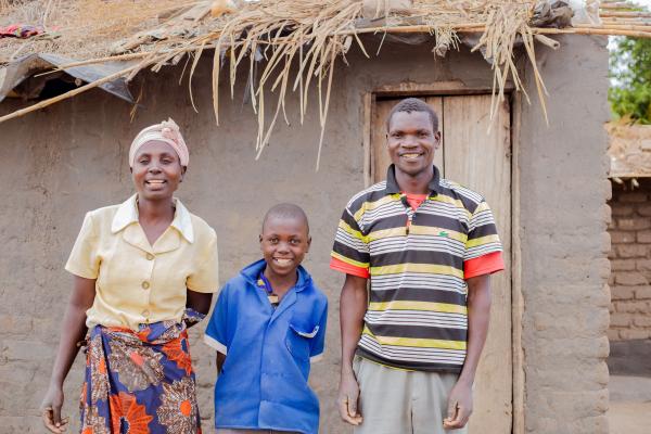 Student Thoko with his mother and father outside their home.