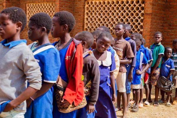 School children queuing up outside a learning centre.