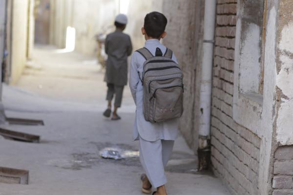 Boy walking along a passageway.
