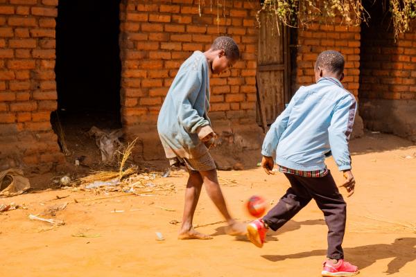 Lonjezo plays football with his friend