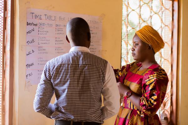 Peter and Prisca look at the learning centre timetable