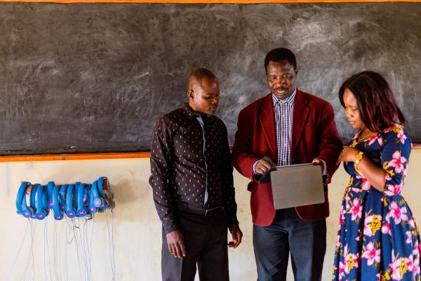 Theonas with Peter and Prisca in the learning centre, looking at the tablets