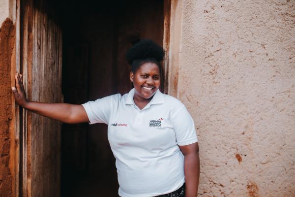 Volunteer Diane stands outside a primary actor's home