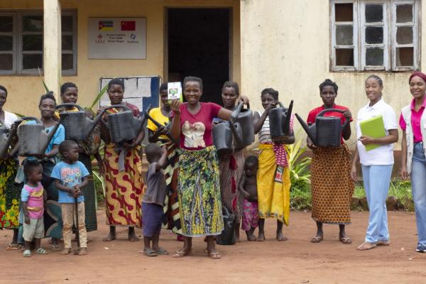Women's group pose with watering cans