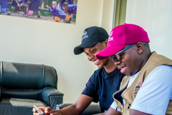 Two volunteers look at phone