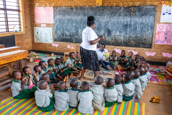 Diane in the classroom with students sat in a circle on the floor.