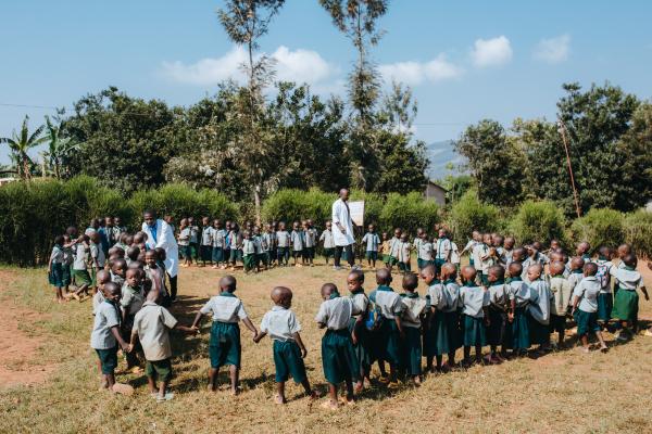 Students stood outside in a circle with their teachers.