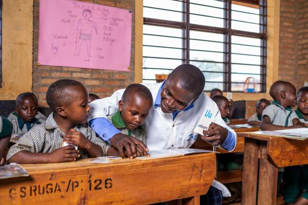 Primary school student Joshua and a classmate in lesson with teacher Olivier.